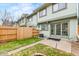 A fenced backyard features a small lawn and a patio, perfect for enjoying outdoor relaxation and privacy at 2297 S Oswego Way, Aurora, CO 80014