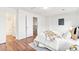 Bedroom with neutral decor and hardwood floors, connecting to bathroom and stairway at 2297 S Oswego Way, Aurora, CO 80014