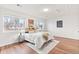Bright bedroom with large windows, hardwood floors, and a comfortable bed at 2297 S Oswego Way, Aurora, CO 80014