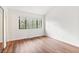 Bright bedroom featuring hardwood floors and a window with natural light at 2297 S Oswego Way, Aurora, CO 80014