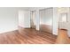 Bedroom with mirrored closet doors and hardwood floors at 2297 S Oswego Way, Aurora, CO 80014