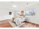 Spacious bedroom featuring a comfortable bed, modern decor, and ample natural light from large windows at 2297 S Oswego Way, Aurora, CO 80014