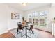 Bright dining area with glass table, comfortable chairs, and backyard access through double doors at 2297 S Oswego Way, Aurora, CO 80014