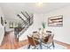Dining area with glass table, modern chairs, staircase, and tasteful decor for an inviting atmosphere at 2297 S Oswego Way, Aurora, CO 80014