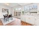 Dining room features a modern table set, white cabinets, and large glass doors to the backyard at 2297 S Oswego Way, Aurora, CO 80014