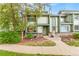Charming two-story home with a lovely front yard, complemented by a lush tree and welcoming entryway at 2297 S Oswego Way, Aurora, CO 80014