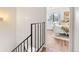 Hallway with wrought iron railing leading to bedroom with natural light at 2297 S Oswego Way, Aurora, CO 80014