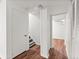 Hallway with access to the stairs, and bedrooms with laminate floors at 2297 S Oswego Way, Aurora, CO 80014