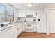 Bright kitchen with white cabinets, stainless steel sink, and granite countertops at 2297 S Oswego Way, Aurora, CO 80014
