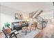 Inviting living room with modern furnishings and a stylish staircase leading to the upper level at 2297 S Oswego Way, Aurora, CO 80014