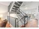 Staircase with black metal railing and carpeted steps leading to a dining area with backyard access at 2297 S Oswego Way, Aurora, CO 80014