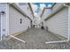 Backyard between homes filled with rocks, utilities, and a view of the street at the end at 4612 S Wenatchee St # A, Aurora, CO 80015