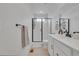 Sleek bathroom with glass shower and modern fixtures, bright lighting, and white tile at 4612 S Wenatchee St # A, Aurora, CO 80015