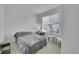 A bright bedroom with a large window, neutral walls, and carpet at 4612 S Wenatchee St # A, Aurora, CO 80015