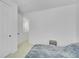 Minimalist bedroom featuring a bed, carpet, and a view of the home's upstairs hallway at 4612 S Wenatchee St # A, Aurora, CO 80015