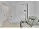 Bedroom with slider closet and reclining chair, illuminated by a modern floor lamp at 4612 S Wenatchee St # A, Aurora, CO 80015