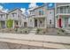 Modern townhome showcases a gray exterior with stone accents and well-kept landscaping at 4612 S Wenatchee St # A, Aurora, CO 80015