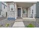 A close-up of the entryway with stacked stone accents surrounding the front door at 4612 S Wenatchee St # A, Aurora, CO 80015