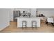 Open concept kitchen with stainless steel appliances and a large center island at 4612 S Wenatchee St # A, Aurora, CO 80015