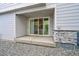 Outdoor patio featuring concrete floor, stone facade, and sliding glass doors that lead into the home at 4612 S Wenatchee St # A, Aurora, CO 80015