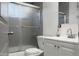 Well-lit bathroom with a sleek, glass-enclosed shower, modern vanity, and contemporary fixtures at 4463 Steele St, Denver, CO 80216