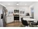 Bright kitchen features stainless appliances, white cabinetry and subway tile backsplash and a breakfast nook at 4463 Steele St, Denver, CO 80216