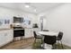 Bright kitchen with stainless steel appliances, white cabinets, subway tile backsplash, and a cozy breakfast area at 4463 Steele St, Denver, CO 80216