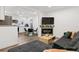 Open concept living space with a modern fireplace and seamlessly connected kitchen and breakfast nook at 4463 Steele St, Denver, CO 80216