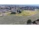 View of a park, open fields, trees, walking paths, and distant cityscape at 8300 W 87Th Dr # B, Arvada, CO 80005