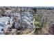 View of townhomes featuring light-colored roofs, brick chimneys, and well-maintained landscaping at 8300 W 87Th Dr # B, Arvada, CO 80005