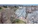 View of townhomes with grey roofs, patios, red brick chimneys, and well-manicured landscaping at 8300 W 87Th Dr # B, Arvada, CO 80005