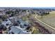View of townhomes near a green space, with walking paths, mature trees, and landscaping at 8300 W 87Th Dr # B, Arvada, CO 80005