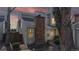 Dusk view of a townhome exterior featuring a red brick chimney and welcoming curb appeal at 8300 W 87Th Dr # B, Arvada, CO 80005