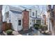 Inviting exterior of a charming townhome with a red brick chimney and a well-maintained front yard at 8300 W 87Th Dr # B, Arvada, CO 80005