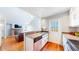 Well-lit kitchen area with stainless steel appliances and hardwood floors, seamlessly connected to a cozy living space at 8300 W 87Th Dr # B, Arvada, CO 80005