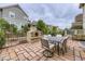 Backyard area with stone gas fireplace and outdoor dining set at 1063 Sandstone Cir, Erie, CO 80516
