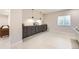 Basement bar area with custom cabinets, stylish pendants, and a convenient mini fridge at 1063 Sandstone Cir, Erie, CO 80516