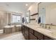 Bright bathroom featuring double sinks, granite counters, soaking tub and separate shower at 1063 Sandstone Cir, Erie, CO 80516