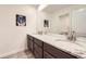 Charming half bathroom featuring granite counters and a large mirror at 1063 Sandstone Cir, Erie, CO 80516