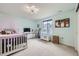 Bright bedroom with a purple-themed bed, storage chest, and natural light at 1063 Sandstone Cir, Erie, CO 80516
