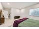 Serene bedroom with light wood floors, a comfortable bed, and a stylish lamp at 1063 Sandstone Cir, Erie, CO 80516