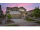 Charming home featuring a two-car garage, covered front porch, and well-maintained landscaping at 1063 Sandstone Cir, Erie, CO 80516