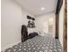 Hallway with black and white patterned floor tiles leading to stairs at 1063 Sandstone Cir, Erie, CO 80516