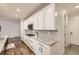The kitchen features sleek white cabinetry, granite countertops, and stainless steel appliances at 1063 Sandstone Cir, Erie, CO 80516