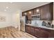 The kitchenette features stainless steel appliances, granite countertops, and wood-look flooring at 1063 Sandstone Cir, Erie, CO 80516