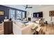 Bright living room featuring stylish furnishings, fireplace, and large windows at 1063 Sandstone Cir, Erie, CO 80516