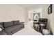 A cozy living room featuring neutral carpeting and comfortable seating at 1063 Sandstone Cir, Erie, CO 80516