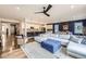 Open-concept living space with a large sofa, modern lighting, and access to the kitchen at 1063 Sandstone Cir, Erie, CO 80516