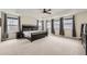 Spacious main bedroom with a tray ceiling and large windows providing ample natural light at 1063 Sandstone Cir, Erie, CO 80516
