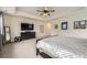 Spacious primary bedroom boasts a tray ceiling, ceiling fan, and en-suite bath at 1063 Sandstone Cir, Erie, CO 80516
